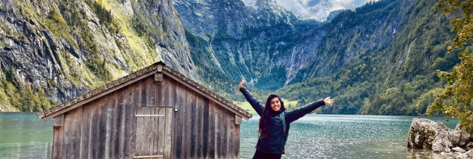 Shreya standing in front of the boathouse on Obersee in Berchtesgaden National Park